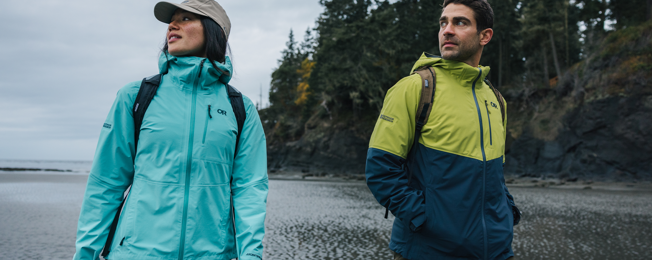 Outdoor Research Alpine Athlete Max Djenohan stands atop a summit while wearing the Foray 3L Jacket.