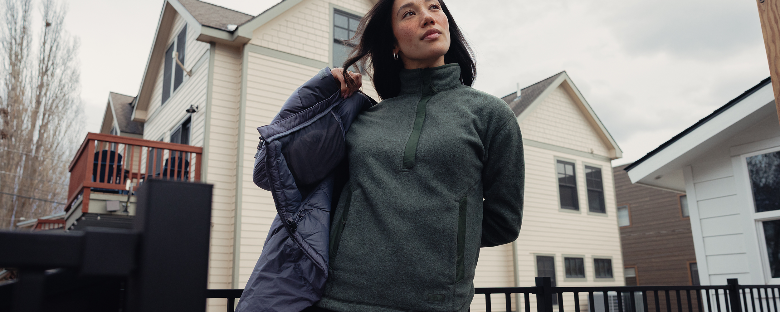 Woman outside wearing Outdoor Research Deming Fleece Pullover Dark Laurel. 