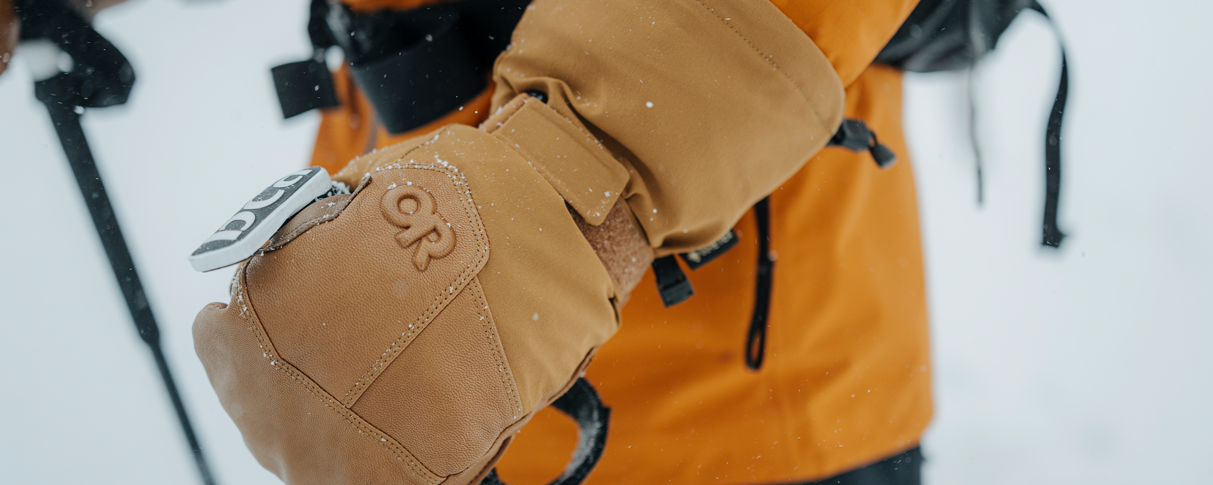 Male wearing Outdoor Research Team Gauntlet GORE-TEX Mitt Dark Natural. 
