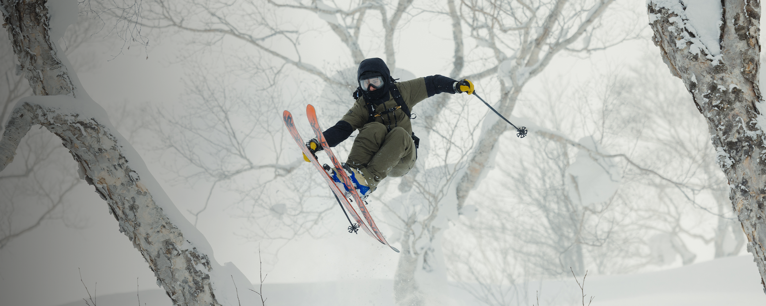 Skier wearing insulated snow pants on a resort run.