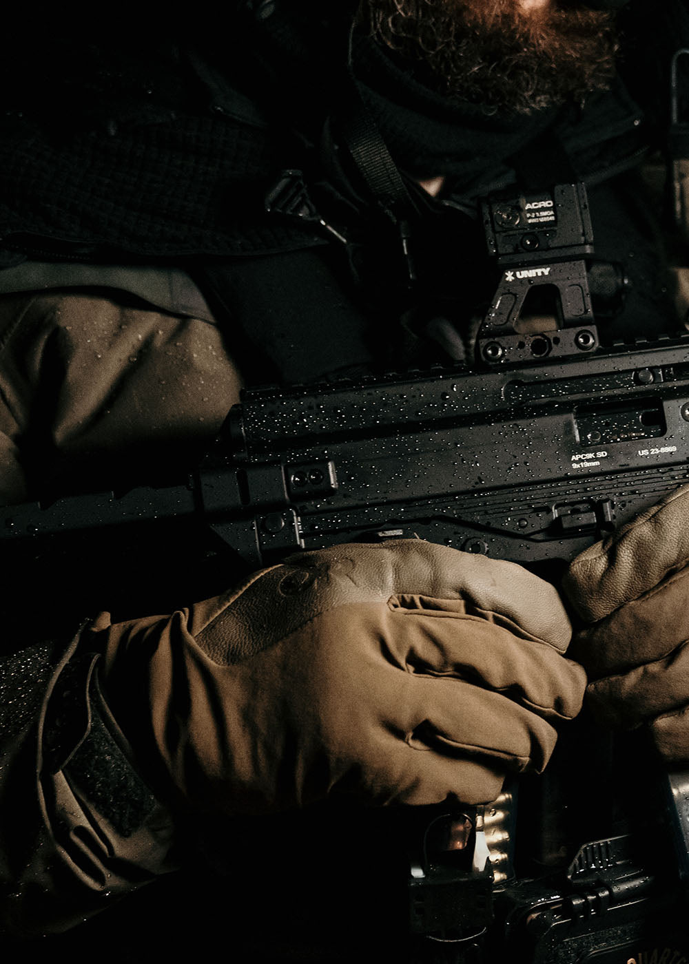 Close up of a person in tactical gear wearing Outdoor Research gloves.