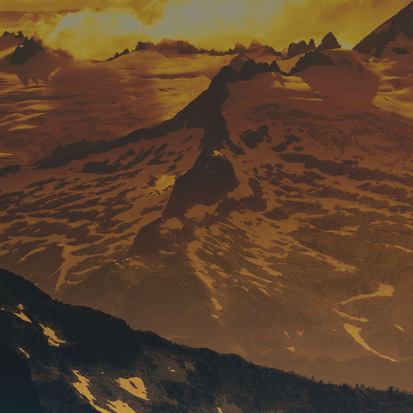 An image of a snow-covered mountain, with a sepia toned overlay.
