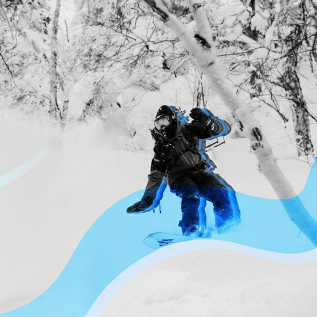 Person snowboarding on a snowy slope with trees in the background.