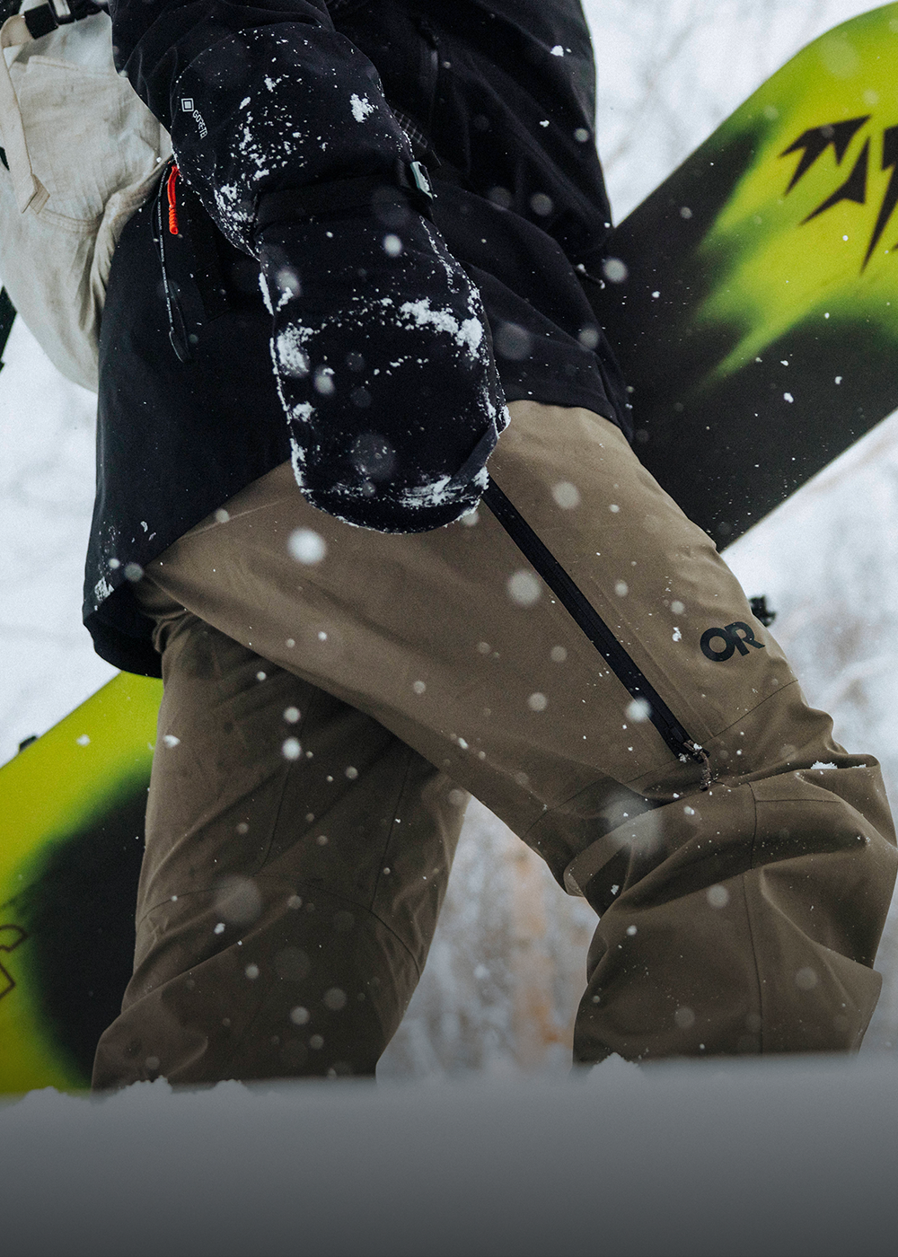 Male in the snow wearing Outdoor Research outerwear. 