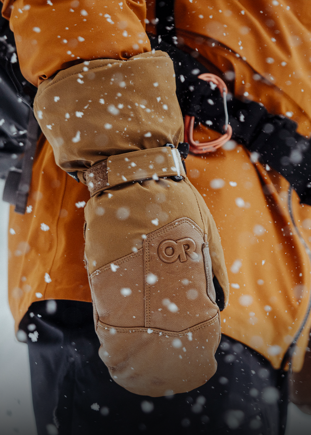 A skier holds their ski poles wearing the Outdoor Research Women's Revolution Undercuff GORE-TEX Gloves in Sable.