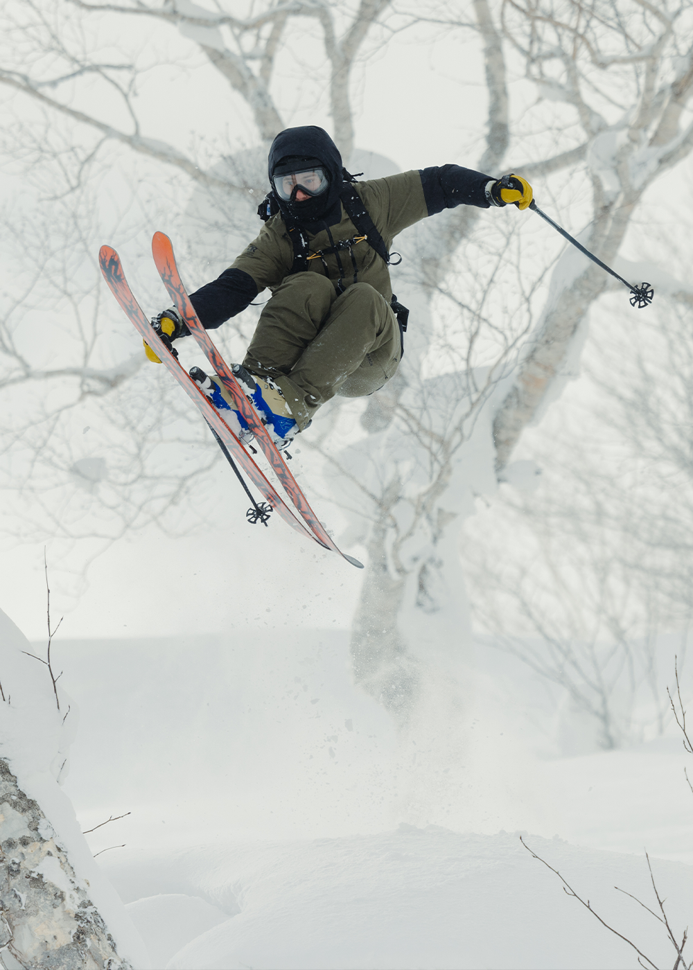 Skier wearing insulated snow pants on a resort run.